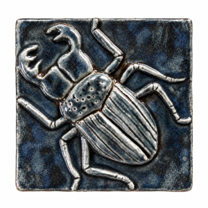 Beetle relief ceramic tile in a blue black glazed finish