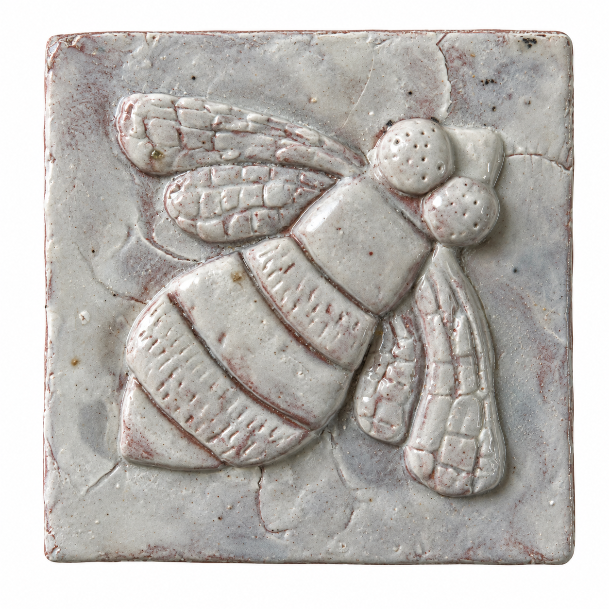 Pale glazed ceramic tile with a raised bee design