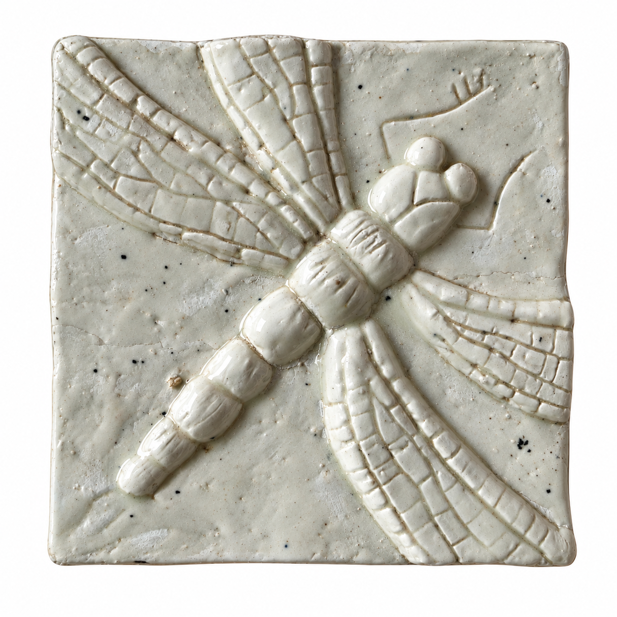 Pale glazed ceramic tile with a raised dragonfly design