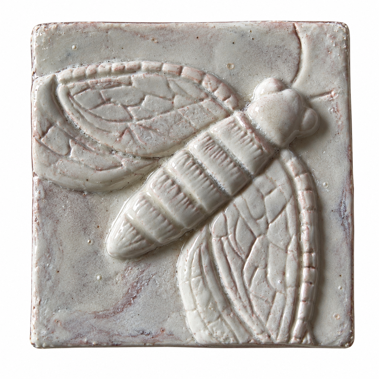 Pale glazed ceramic tile with a raised winged insect design