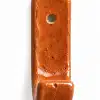 Single ceramic wall hook with an orange terracotta coloured finish