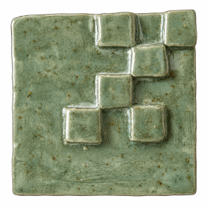 Stepped geometric relief ceramic tile in a green glazed finish