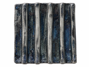 Moody blue glazed ceramic tile with raised parallel ridges